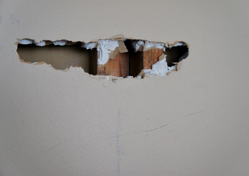 large%20hole%20in%20grey%20dry-wall%20exposing%20wood%20studs large%20hole%20in%20grey%20dry-wall%20exposing%20wood%20studs
